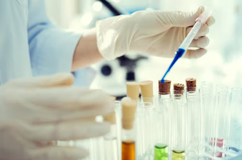 Biotechnology student performing microscope-based laboratory analysis